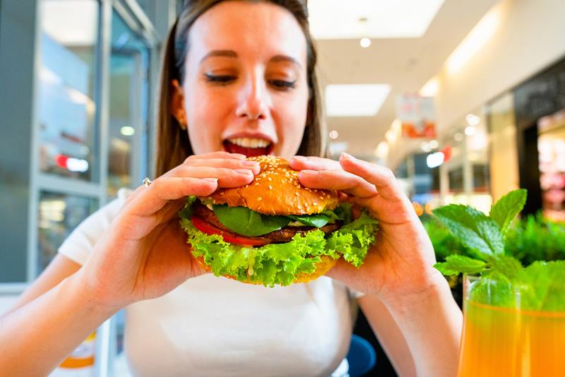 Girl eating a vegetarian B12 burger